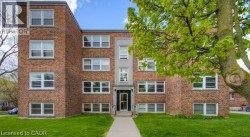 Brick exterior facade with multiple windows and a central entrance - 