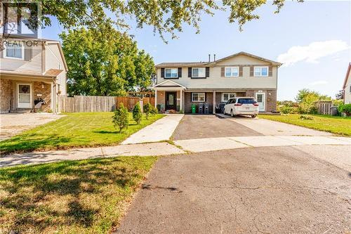 Two-story residence featuring light-colored siding and dark shutters - 52 Charters Road, Brampton, ON 
