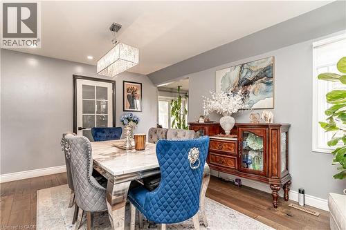 Hardwood-style flooring throughout, recessed lighting, and a modern rectangular crystal chandelier - 52 Charters Road, Brampton, ON 