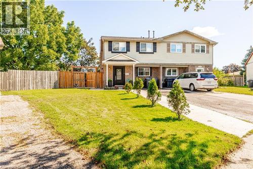 Two-story exterior with light-colored siding and dark shutters - 52 Charters Road, Brampton, ON 
