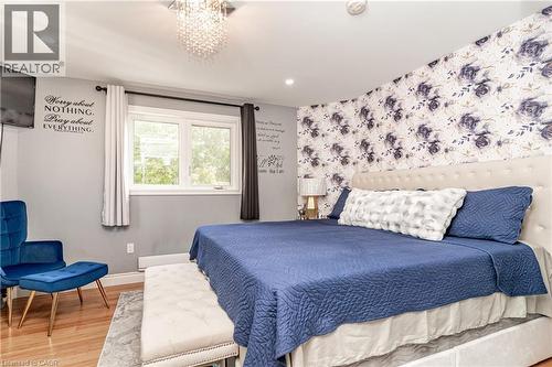 Recessed lighting, wood-finish flooring, and a decorative accent wall - 52 Charters Road, Brampton, ON 