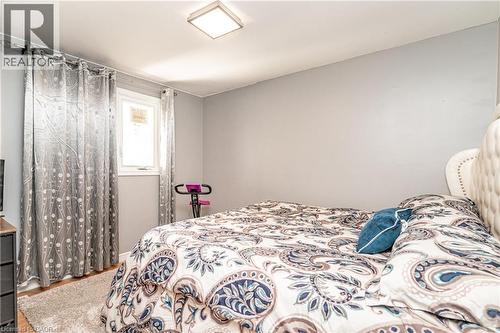 Neutral wall paint, square flush mount ceiling light, and wood-finish flooring - 52 Charters Road, Brampton, ON 