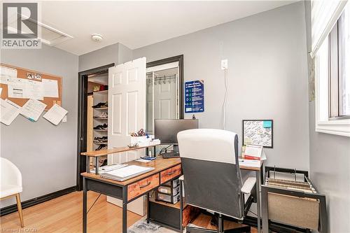 Recessed attic access hatch, light wood-finish flooring, white window blinds, white paneled door, built-in closet shelving - 52 Charters Road, Brampton, ON 