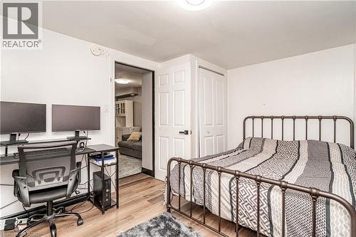 Wood-finish flooring with white walls and a paneled bifold closet door - 52 Charters Road, Brampton, ON 