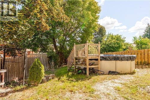 Backyard featuring an above-ground pool with a wooden deck and privacy fencing - 52 Charters Road, Brampton, ON 