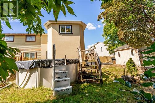Expansive backyard featuring an above-ground pool with stairs, a detached storage shed, and mature trees - 52 Charters Road, Brampton, ON 