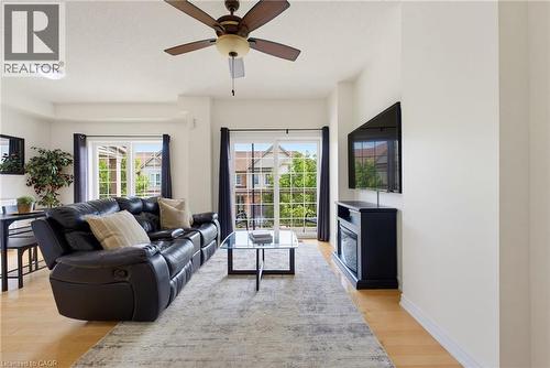 Recessed lighting, ceiling fan, wood-finish flooring, and a built-in electric fireplace - 541 Winston Road Unit# 50, Grimsby, ON 