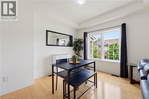 Hardwood flooring, recessed ceiling, and a large window with white framing - 541 Winston Road Unit# 50, Grimsby, ON 