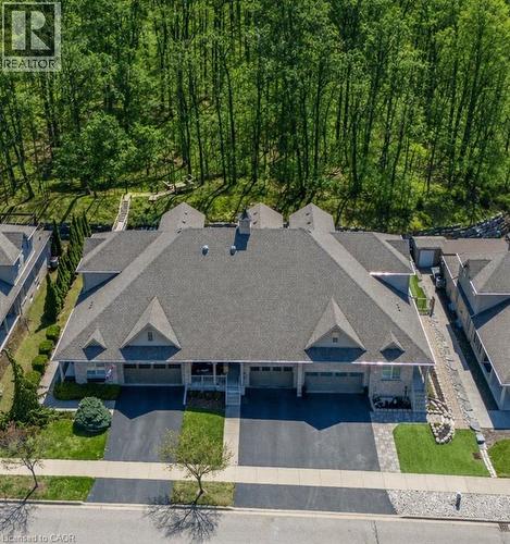 Stone facade exterior with integrated garages, asphalt driveways, and a shingled roof - 227 Chestnut Hill Crescent, Kitchener, ON 