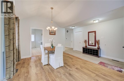 Vaulted ceiling with a chandelier, wood-finish flooring, recessed lighting, and a white interior door - 245 Fern Crescent, Waterloo, ON 