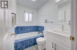 White vanity with integrated sink, chrome faucet, and framed mirror - 