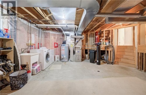 Unfinished basement with exposed ceiling joists and concrete flooring - 245 Fern Crescent, Waterloo, ON 