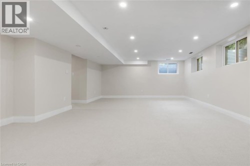 Recessed lighting, light-toned carpeting, multiple windows, and white trim accents - 293 North Shore Boulevard E, Burlington, ON 