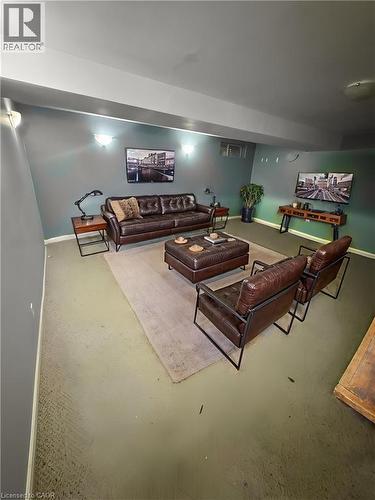 Finished basement recreation room featuring recessed lighting, neutral wall finishes, and polished concrete flooring throughout - 717 Activa Avenue, Kitchener, ON 