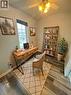 Wood-finish flooring, a ceiling fan with integrated lighting, and a large window with roller shades - 717 Activa Avenue, Kitchener, ON 