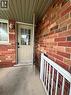 Brick exterior with contrasting trim, covered entry, and a white aluminum railing - 717 Activa Avenue, Kitchener, ON 