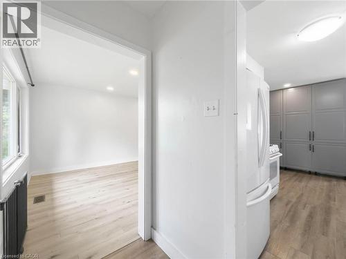 Recessed lighting, wood-finish flooring, white walls, double-pane window, and full-height built-in cabinetry - 220 Cairn Street, London, ON 