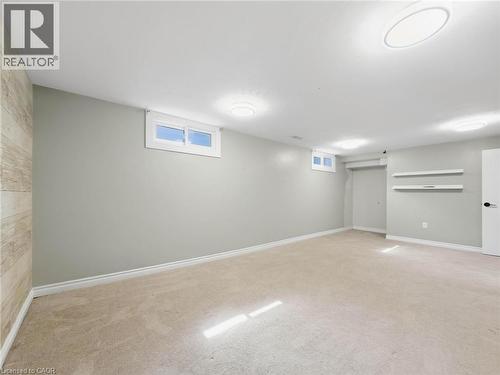 Finished room featuring neutral carpeting, light gray wall paint, and recessed windows - 220 Cairn Street, London, ON 