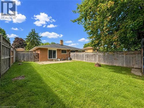 Expansive lawn area with a perimeter wood fence - 220 Cairn Street, London, ON 