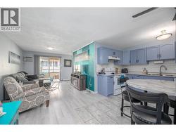 A bright open-concept layout connects the updated kitchen, dining area and comfortable living room. - 