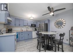 The refreshed kitchen features colourful cabinetry, generous counter space and a casual dining area. - 