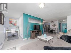 A flexible office nook beside the living room creates a convenient work-from-home space. - 