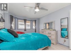 Multiple windows bring natural light into the comfortable primary bedroom. - 