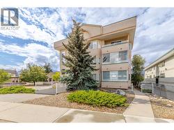 Landscaped grounds and mature trees frame the front of Westbrook Court. - 