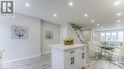 Kitchen island with solid surface countertop and cabinet storage - 