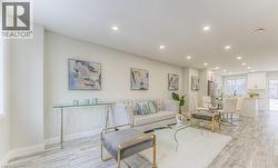 Expansive open-concept space featuring recessed lighting, light wood-finish flooring, and white walls - 