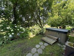 Hot tub tucked behind the house off the side deck - 