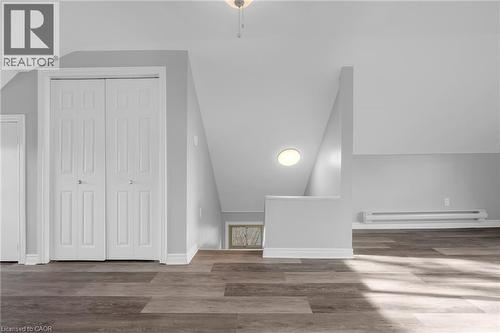 Wood-finish flooring with bi-fold closet doors, sloped ceilings, and perimeter baseboard heating - 9 Melrose Avenue S Unit# Upper, Hamilton, ON 