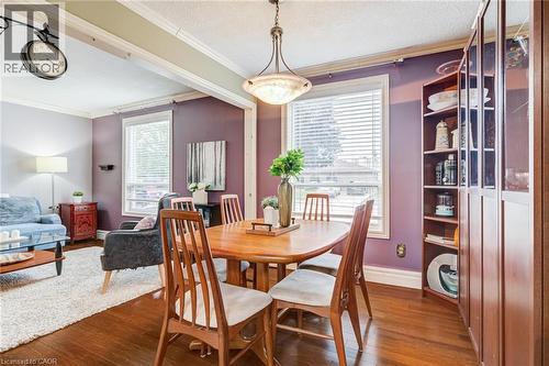 Hardwood-finish flooring, built-in shelving, two large windows with blinds, and ceiling-mounted lighting - 106 Appleford Road, Hamilton, ON 