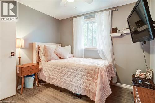 Wood-finish flooring, single window, and a ceiling fan - 106 Appleford Road, Hamilton, ON 