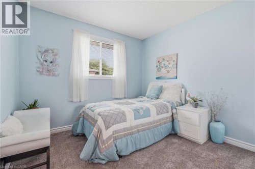 Blue-painted walls, carpet flooring, and a single window with blinds - 9 Country Club Road, Cayuga, ON 
