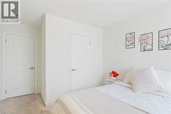 Wall-to-wall carpeting and white interior doors with satin nickel hardware - 