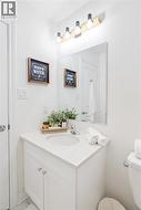 White vanity with an integrated sink, polished chrome faucet, and a rectangular mirror - 
