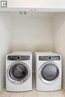 Built-in laundry nook with light-toned tiled flooring - 