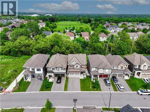 Expansive residential neighborhood with mature trees and a distant recreational field - 68 Barkerville Drive, Whitby, ON 