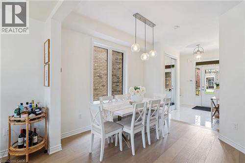 Recessed lighting, wood-finish flooring, white trim, and a three-light linear pendant fixture - 68 Barkerville Drive, Whitby, ON 