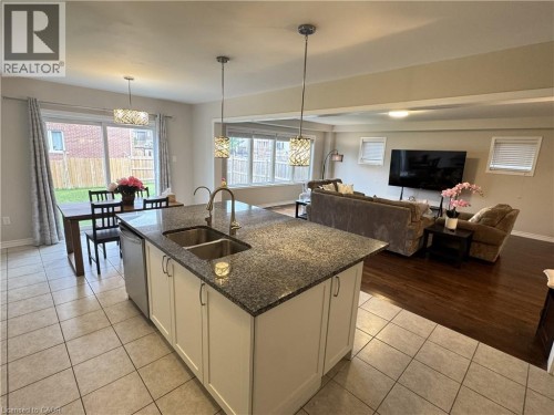 Kitchen island with a double basin sink and granite-style countertop - 67 Pointer Street, Cambridge, ON 