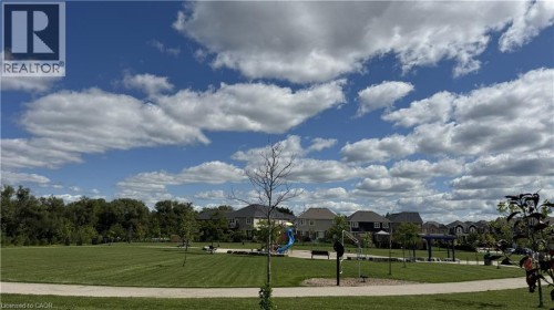 Expansive park area featuring a manicured lawn, paved pathways, and mature trees - 67 Pointer Street, Cambridge, ON 