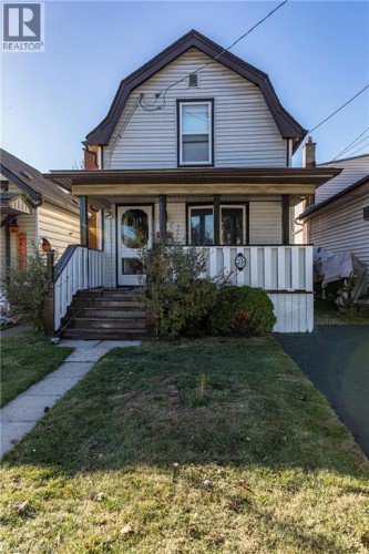 Siding exterior with a gambrel roofline - 23 Frederick Avenue, Hamilton, ON 