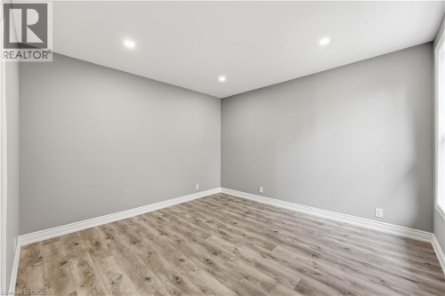 Recessed lighting, wood-finish flooring, white trim, and light gray wall finishes - 98 Duke Street Unit# 2Nd, Hamilton, ON 