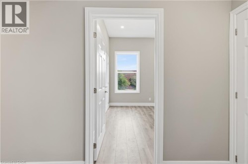 Light wood-finish flooring, white trim, recessed lighting, white window frame - 98 Duke Street Unit# 2Nd, Hamilton, ON 