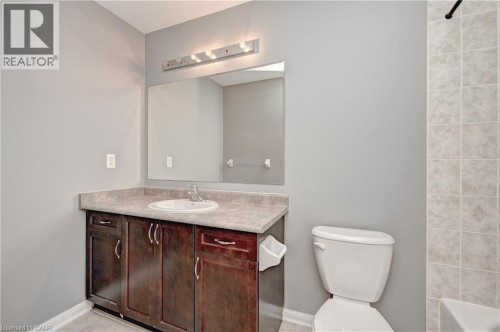 Dark wood-finish vanity with a built-in sink and countertop - 103 Blackbird Circle, Cambridge, ON 