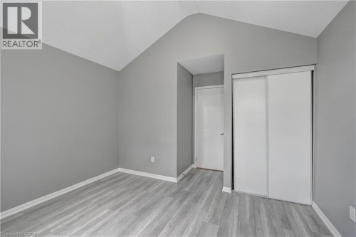 Vaulted ceiling accentuates this space featuring wood-finish flooring - 103 Blackbird Circle, Cambridge, ON 