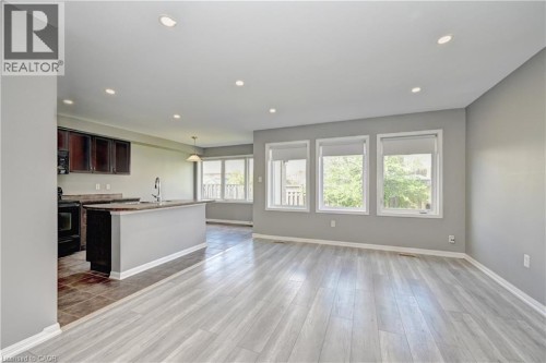 Spacious open-concept layout with wood-finish flooring and recessed lighting - 103 Blackbird Circle, Cambridge, ON 
