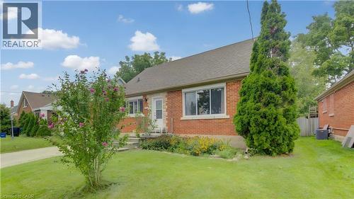 Brick exterior with a gabled roof and white trim - 104 Mausser Avenue, Kitchener, ON 
