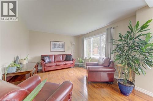 Hardwood-finish flooring, neutral wall paint, and a large window with natural light - 104 Mausser Avenue, Kitchener, ON 